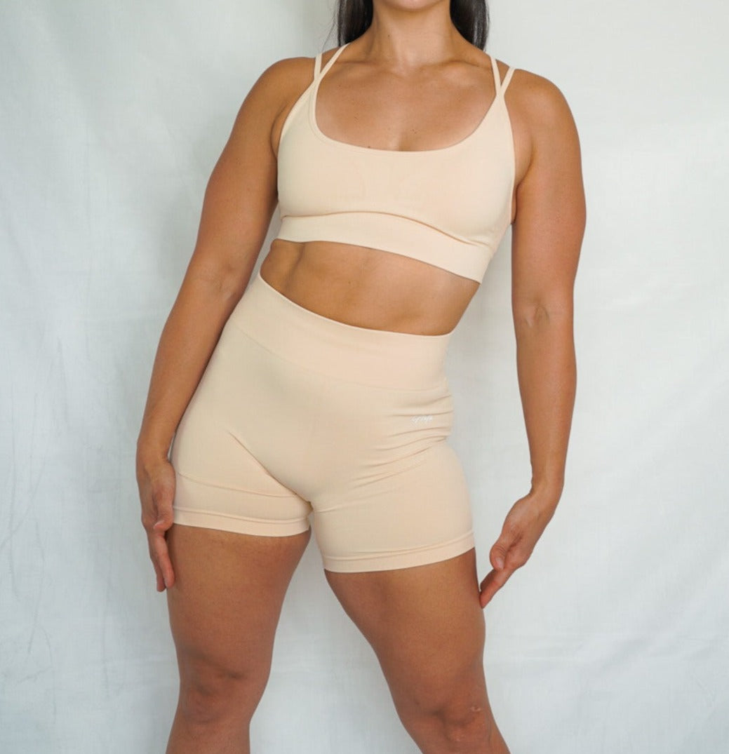 5 inch inseam shorts seamless scrunch short and strappy back comfortable seamlless sports bra front view in cosmic latte