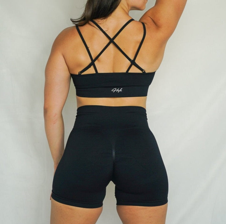 5 inch inseam shorts seamless scrunch short and comfortable strappy back seamless sports bra back view in black