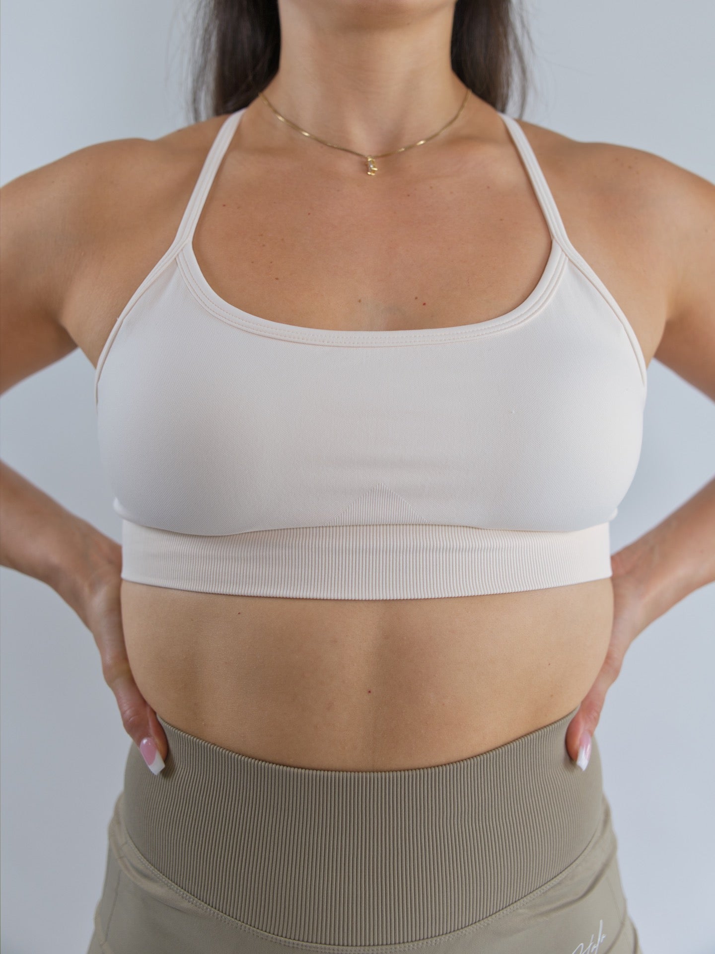 strappy back sports bra off white sweet cream front view close up